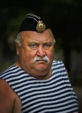 Мужчина в полосатой майке и фуражке