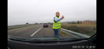 Человек в светоотражающем жилете на обочине дороги