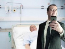 Человек в костюме делает селфи в больнице