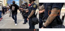 Митингующие и полицейские на улице, видны татуировки