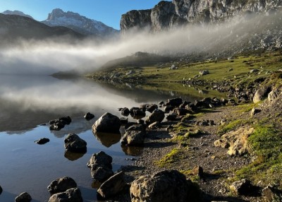 Горное озеро с камнями и туманом на берегу в Испании
